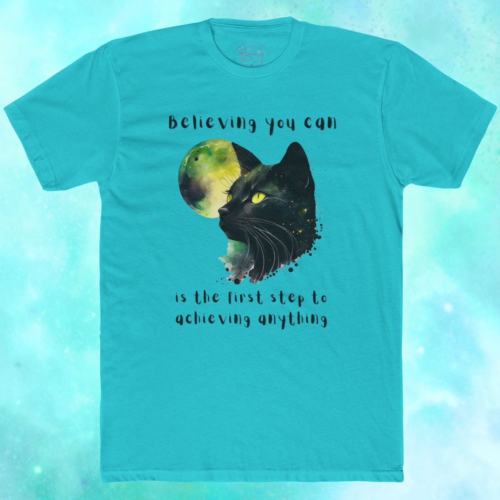 Teal t-shirt with a black cat graphic and motivational quote on a blue gradient background
